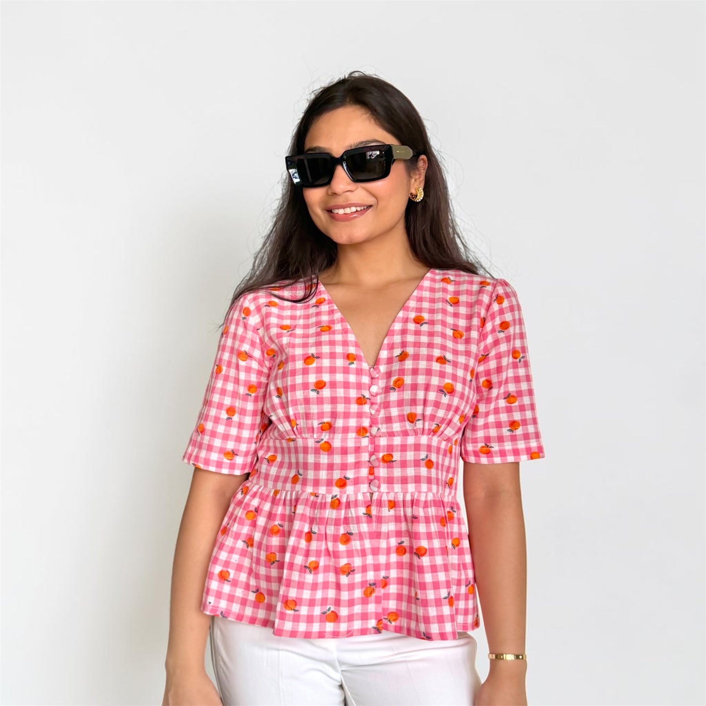Gingham Peach Top front view — peach print over pink gingham, peplum silhouette | Kodds